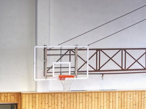 Basketball transparent backboard with basket in the gym. White background. 