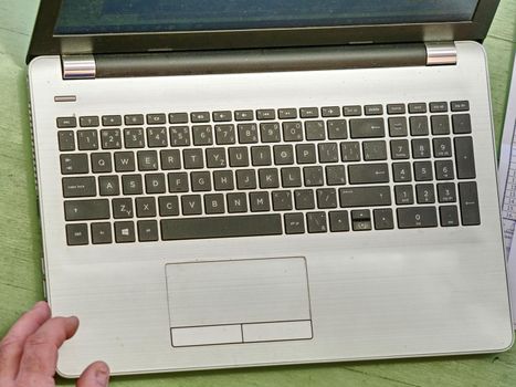 Old hands with wrinkles typing on laptop. Modern old pensioner working from home. Close up view of elderly woman's hands