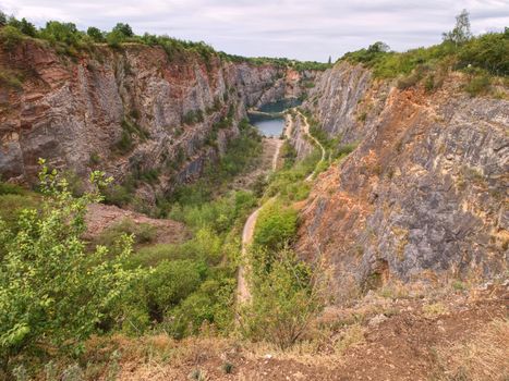 Great old quarry for dolomite mining. Blue lagoon in middle with wooden bridge for tourists.