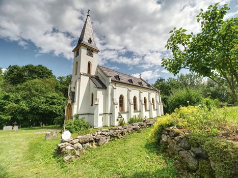 Church and graveyard in Zadni Zvonkova,  a border village ruined by the communist regime.  15th of July 2019, Zadni Zvonkova, Czech Republic. 