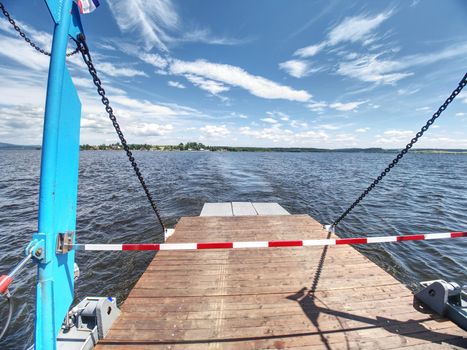 Shipping on Ferry Boat Ship with open Ramp and empty Car Deck. Wooden board for cars and passenger