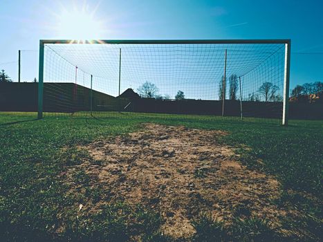 Soccer football net background over green grass and blurry stadium. Football,soccer field. Football,soccer and goal background. Soccer goal