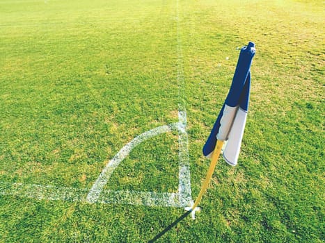 White blue flag in corner of football playground, lazy wind blowing