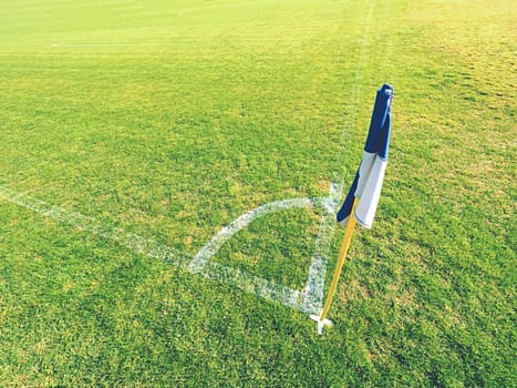 White blue flag in corner of football playground, lazy wind blowing