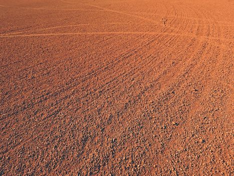 Dry light red crushed bricks surface on outdoor tennis playground court 