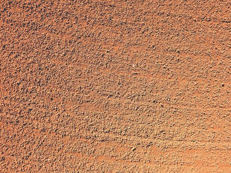Dry light red crushed bricks surface on outdoor tennis playground court 