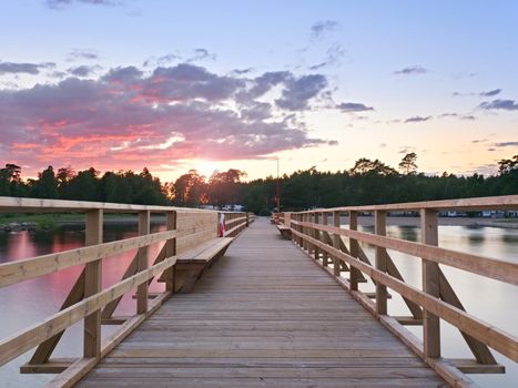 Long wooden pier on the Baltic coast during morning. Cold weather, cold water. New built attraction in summer holiday resort. Empty mole.