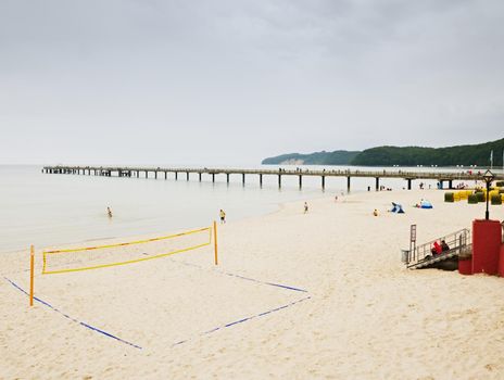 18th of August 2017, Binz, Germany. Morning beach with empty volleyball playground and few relaxing people. The Baltic sea beach