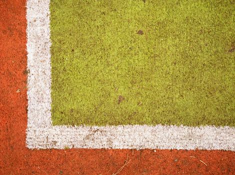 Green Tartan race track with white lines. Colorful lines in empty outdoor handball playground, plastic light green surface