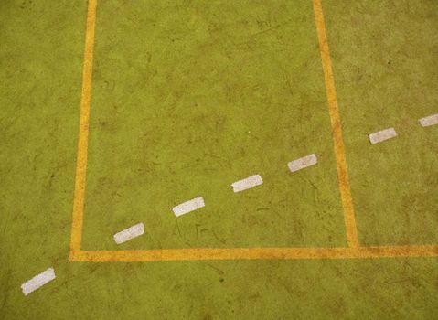 Border lines on court. Worn out green red hairy carpet on outside hanball playground. Jogging area  outdoor stadium with a tartan track.