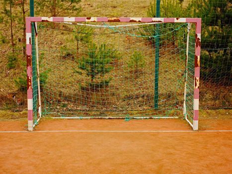 Soccer football net background over green grass and blurry stadium. Close up detail of a soccer net Footballsoccer field.  

