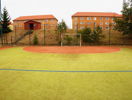 On the football field without goal keeper. Outdoor turf play field.  Old playground at school.