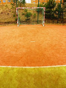 On the football field without goal keeper. Outdoor turf play field.  Old playground at school.