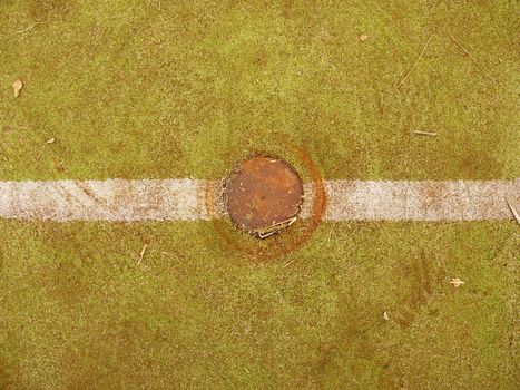 Green Tartan race track with white lines. Colorful lines in empty outdoor handball playground, plastic light green surface