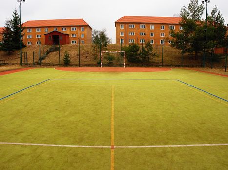 On the football field without goal keeper. Outdoor turf play field.  Old playground at school.