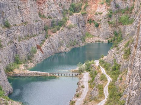 Grand canyon ov abandoned quarry of dolomite source mine. Beautiful quarry with blue water. Water reservoir  