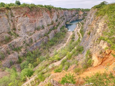 Grand canyon ov abandoned quarry of dolomite source mine. Beautiful quarry with blue water. Water reservoir  