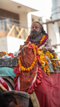 Haridwar, Uttarakhand. India- March 5, 2021- Indian sadhus coming to Kumbh Mela, Royal welcome. Sadhus sitting in rides, wearing a garland,