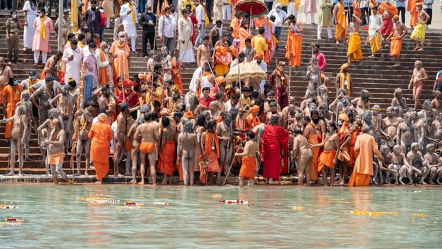 Haridwar, Uttarakhand India April 06, 2021. A Dip of Spirituality and faith, Maha Kumbh 2021. Morning Time dip, Indian saints batting in Ganges of Ganga River and Worshipping their God. High-quality