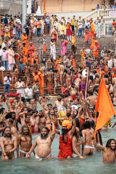 Haridwar, Uttarakhand India April 06, 2021. A Dip of Spirituality and faith, Maha Kumbh 2021. Morning Time dip, Indian saints batting in Ganges of Ganga River and Worshipping their God. High-quality