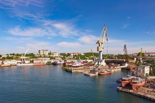 Aerial view of the cityscape overlooking the port with ships and cranes. Sevastopol, Crimea