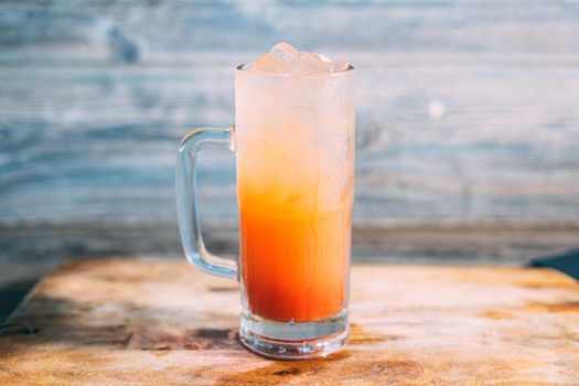 A glass of tequila sunrise drink