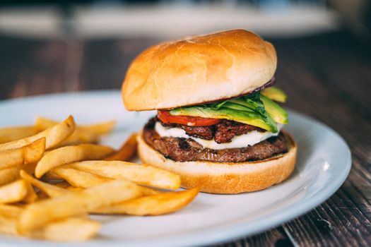 A plate of juicy hamburger and fries