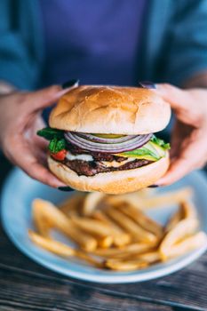 A plate of juicy hamburger and fries