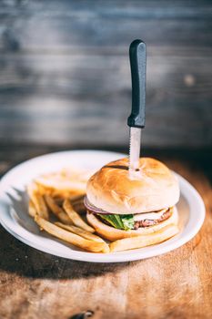 A plate of juicy hamburger and fries