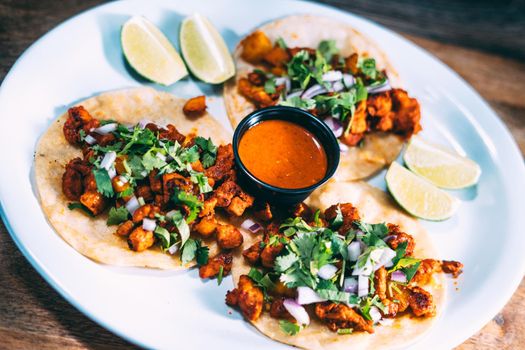 A plate of tacos and tortilla snacks