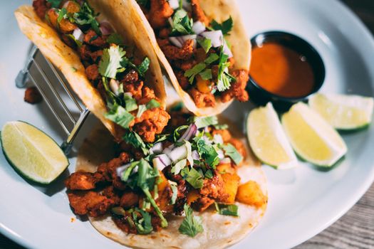 A plate of tacos and tortilla snacks