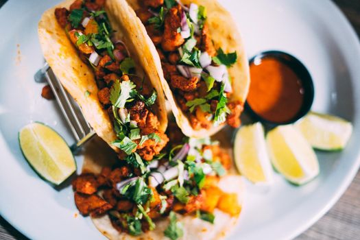 A plate of tacos and tortilla snacks