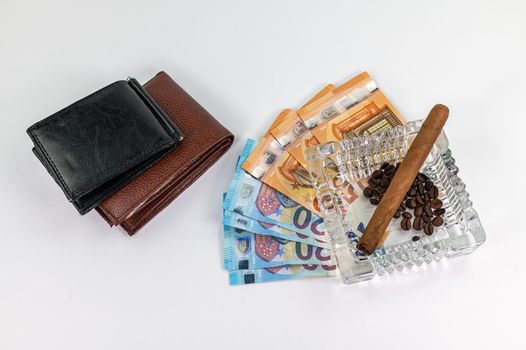 20 and 50 euro banknotes and wallet and cigar on a white background