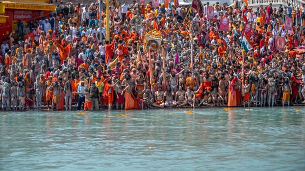 Haridwar, Uttarakhand India April 06, 2021. A Dip of Spirituality and faith, Maha Kumbh 2021. Morning Time dip, Indian saints batting in Ganges of Ganga River and Worshipping their God. High-quality