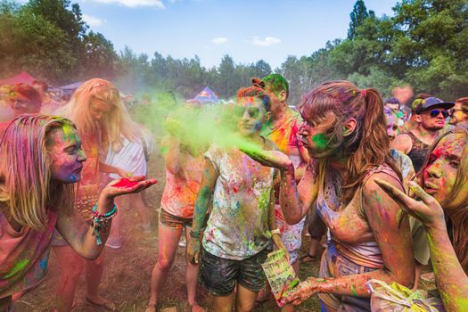 Holi colors holiday. Crazy crowd of young people having fun during festival of colors ColorFest in Kyiv, Ukraine