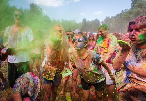 Holi colors holiday. Crazy crowd of young people having fun during festival of colors ColorFest in Kyiv, Ukraine