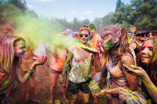 Holi colors holiday. Crazy crowd of young people having fun during festival of colors ColorFest in Kyiv, Ukraine