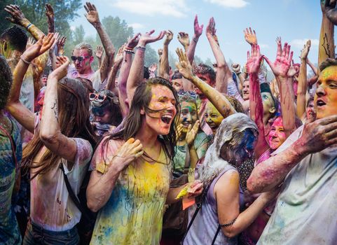 Holi colors holiday. Crazy crowd of young people having fun during festival of colors ColorFest in Kyiv, Ukraine