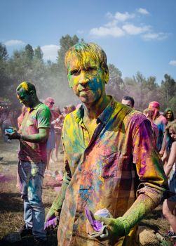 Holi colors holiday. Crazy crowd of young people having fun during festival of colors ColorFest in Kyiv, Ukraine