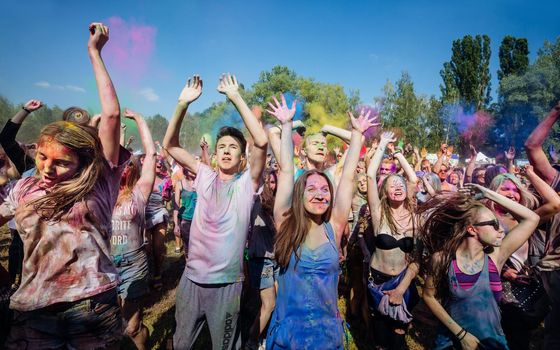 Holi colors holiday. Crazy crowd of young people having fun during festival of colors ColorFest in Kyiv, Ukraine