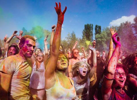 Holi colors holiday. Crazy crowd of young people having fun during festival of colors ColorFest in Kyiv, Ukraine