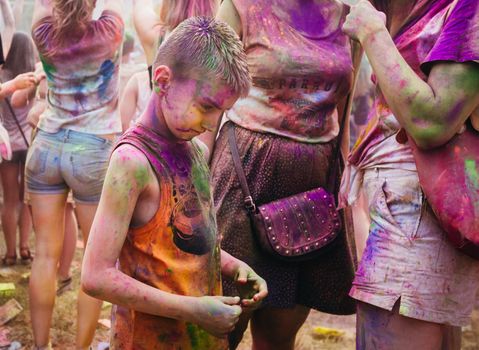 Holi colors holiday. Crazy crowd of young people having fun during festival of colors ColorFest in Kyiv, Ukraine