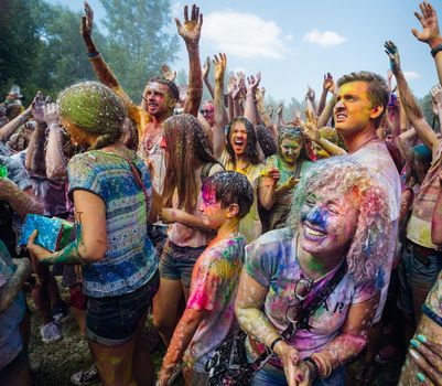 Holi colors holiday. Crazy crowd of young people having fun during festival of colors ColorFest in Kyiv, Ukraine