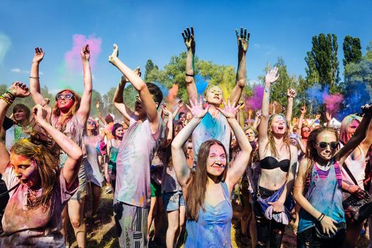 Holi colors holiday. Crazy crowd of young people having fun during festival of colors ColorFest in Kyiv, Ukraine