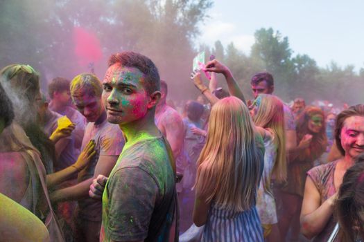 Holi colors holiday. Crazy crowd of young people having fun during festival of colors ColorFest in Kyiv, Ukraine