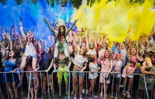 Holi colors holiday. Crazy crowd of young people having fun during festival of colors ColorFest in Kyiv, Ukraine