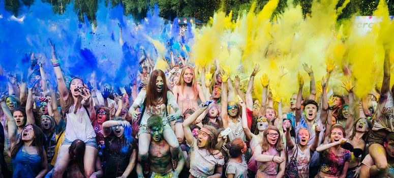 Holi colors holiday. Crazy crowd of young people having fun during festival of colors ColorFest in Kyiv, Ukraine