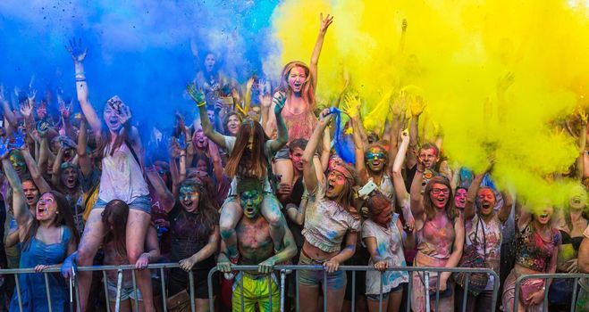 Holi colors holiday. Crazy crowd of young people having fun during festival of colors ColorFest in Kyiv, Ukraine