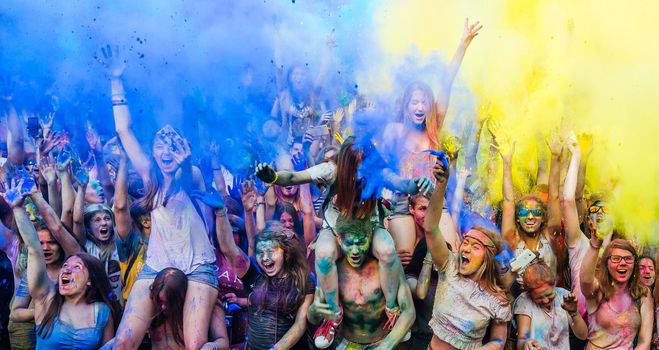 Holi colors holiday. Crazy crowd of young people having fun during festival of colors ColorFest in Kyiv, Ukraine