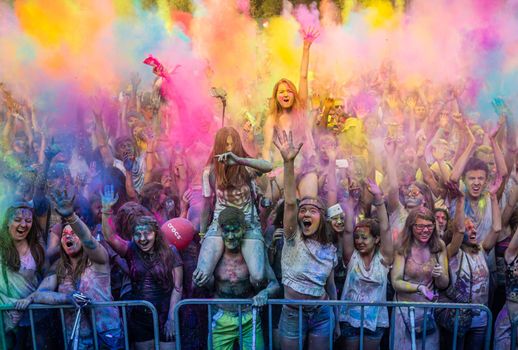 Holi colors holiday. Crazy crowd of young people having fun during festival of colors ColorFest in Kyiv, Ukraine